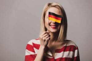 woman holding german flag and smiling