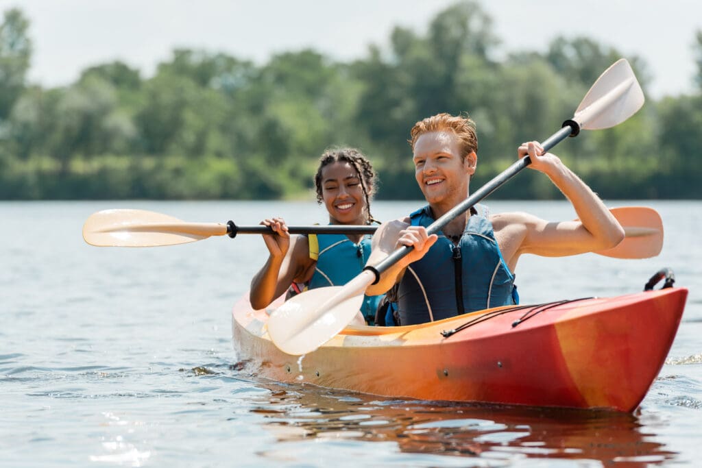 A picture of two smiling people on a kayaking tour.